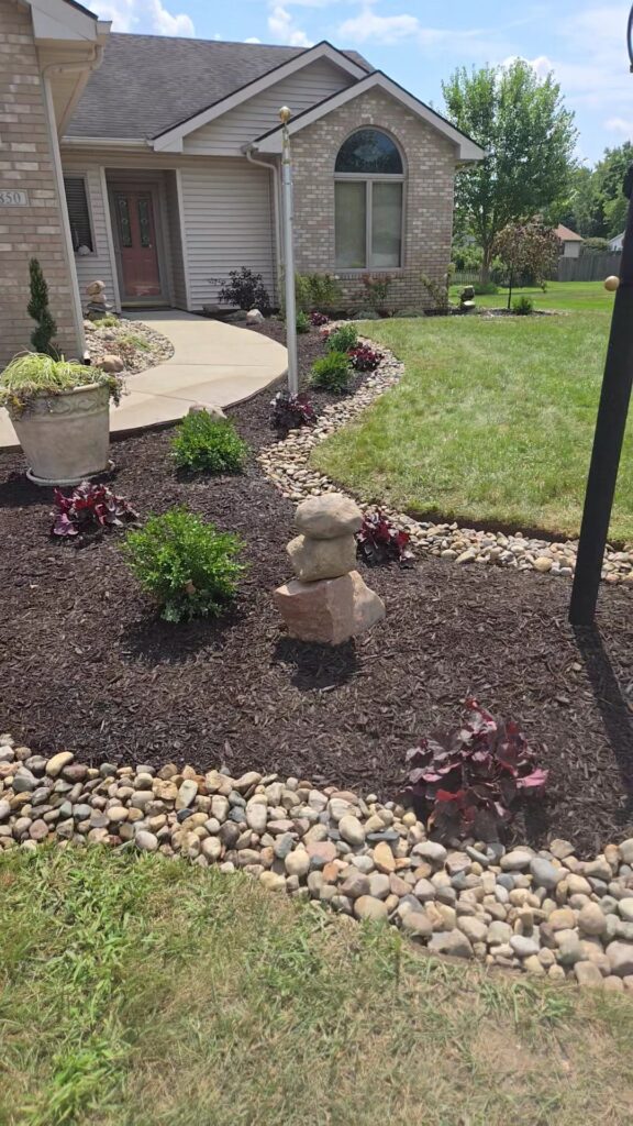 stacked rock cairn mulch trenched bed landscape design New Haven Indiana